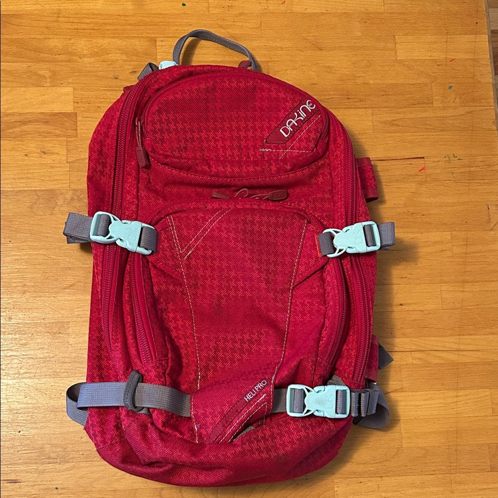 Dakine Snowboarding Red Backpack with Gray Straps and Light Blue Buckles